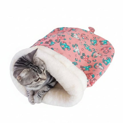 Cat inside a pink patterned pet bed on a light surface