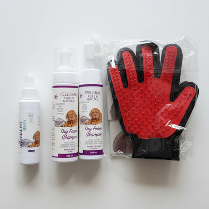 Pet care products including bottles and a glove on a surface.