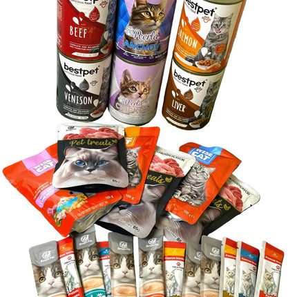 Assorted cat food cans and packets on a green surface
